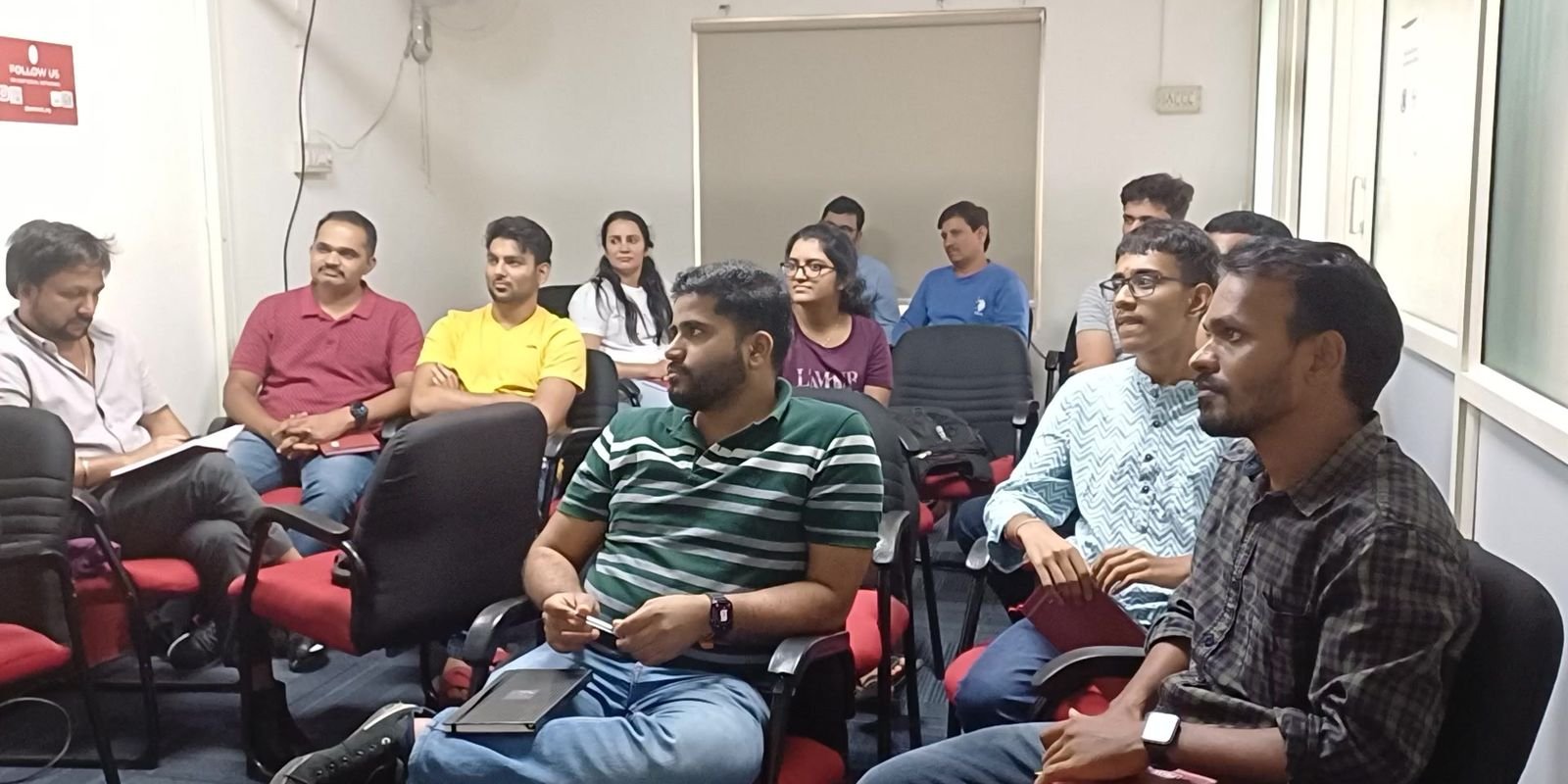 Working professionals in discussion during a Business Communication class at Protocol