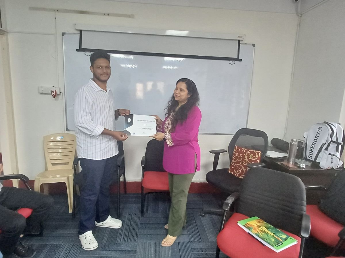 A participant receiving his Protocol course completion certificate in front of the batch