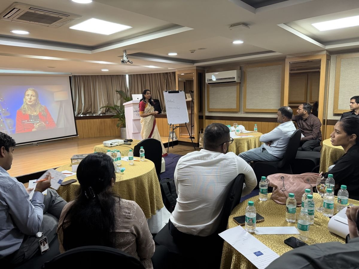 Professionals at round tables during a Protocol corporate workshop at an offsite venue
