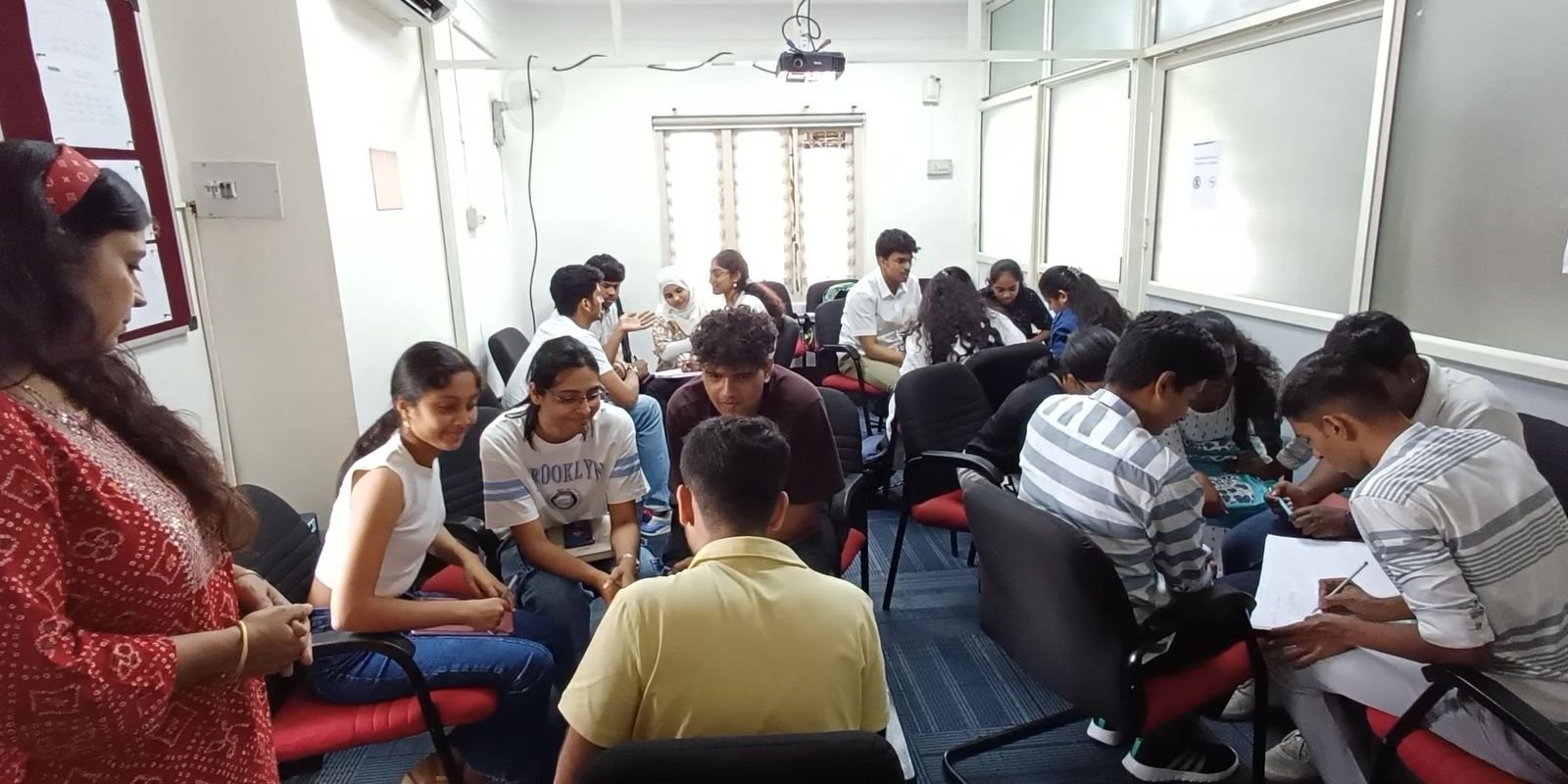A Personality Development batch in group discussion with the trainer at Protocol